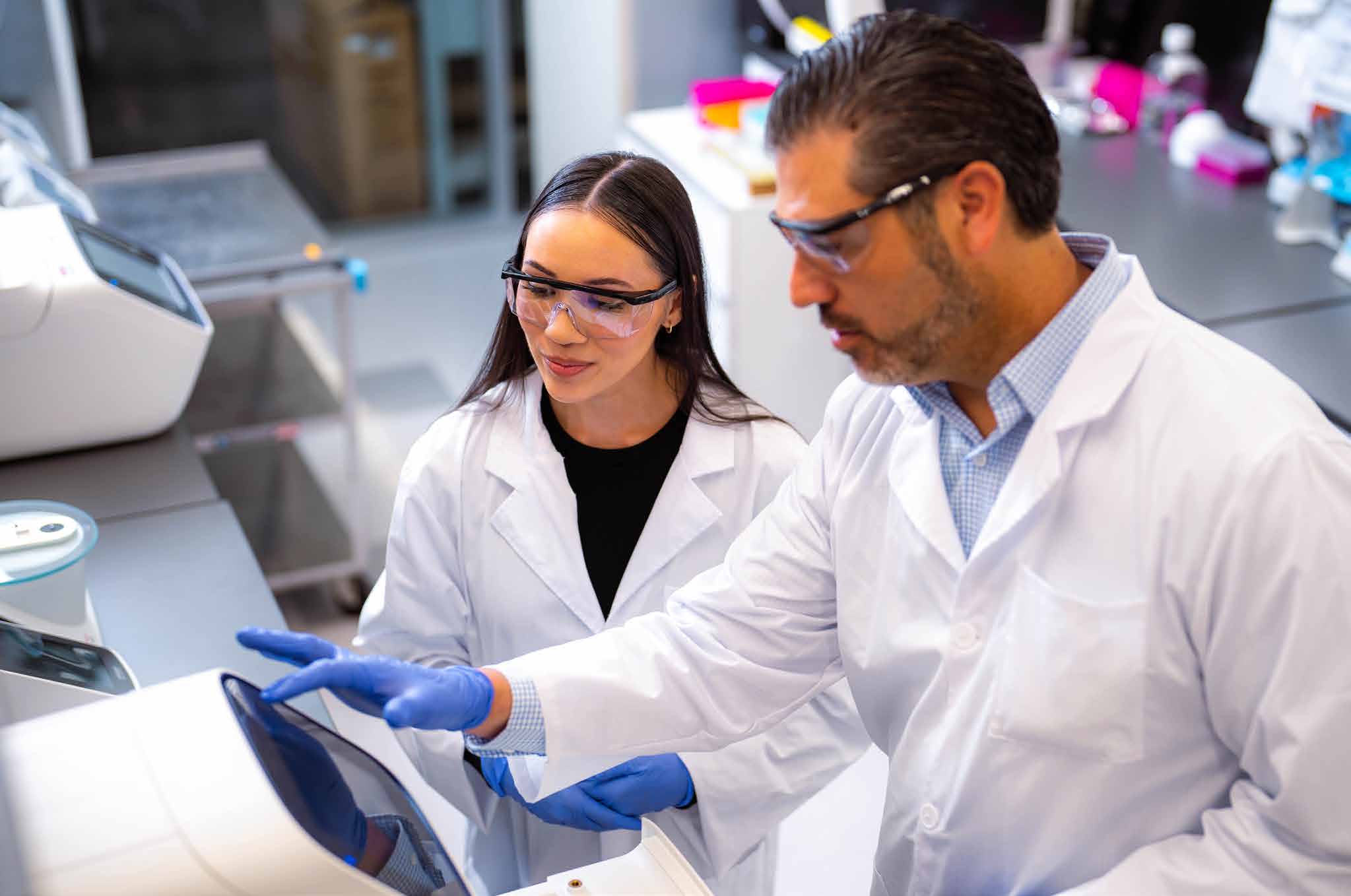 Scientists using laboratory analysis instruments