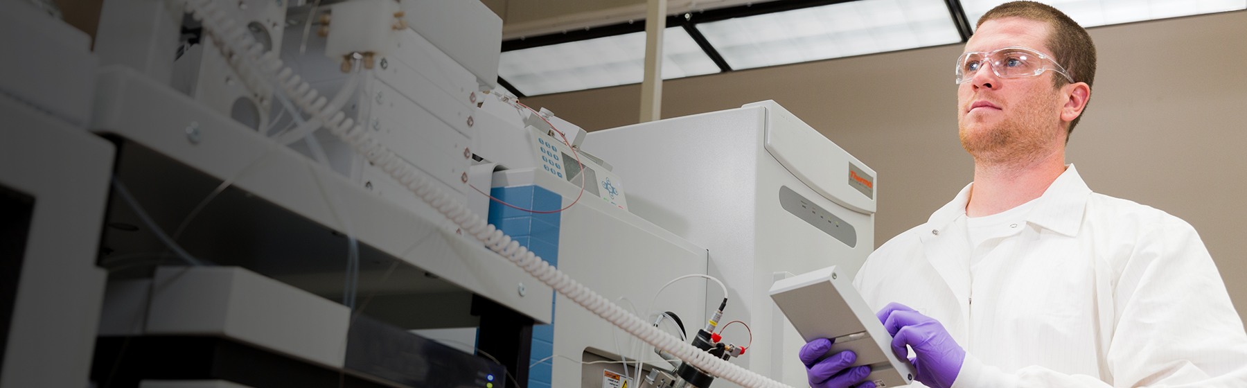 Scientist working with analytical laboratory instruments